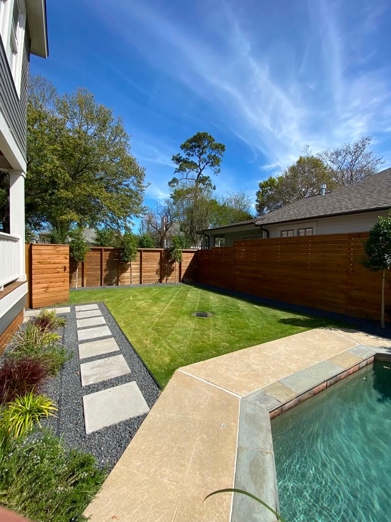Freshly mowed and edged residential lawn maintained by Rainlandscaping